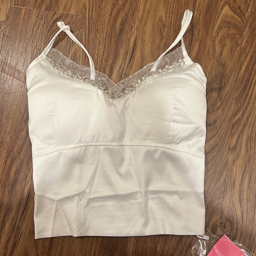 Brand new. It fits s-m small breasts, very nice top.